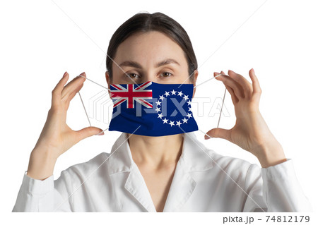 Respirator with flag of Cook Islands Doctor puts on medical face mask isolated on white background Respirator with flag of Cook Islands Doctor puts on medical face mask isolated on white background 74812179