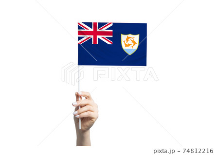 Beautiful female hand holding Anguilla flag, isolated on white background Beautiful female hand holding Anguilla flag, isolated on white background 74812216