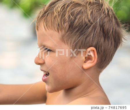 Side portrait mischievous boy, freckled nose, open mouth intriguing cunning mood, smile laugh face expression gestures. Joys Happy Childhood relationship behaviour education parenthood. Funny photo Side portrait mischievous boy, freckled nose, open mouth intriguing cunning mood, smile laugh face expression gestures. Joys Happy Childhood relationship behaviour education parenthood. Funny photo 74817695