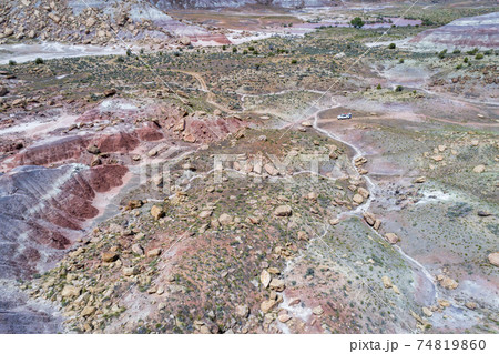 SUV car in rocky desert - aerial view SUV car in rocky desert - aerial view 74819860