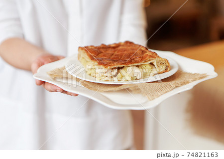 Chicken and potato pie on the dining table. The food is ready to eat. Puff pastry. kitchen utensils for cooking 74821163