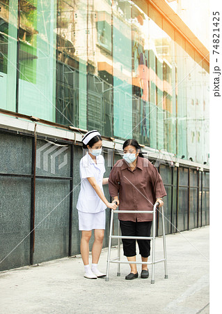 Nurse is helping Senior Elderly Asian Woman uses Zimmer frame walker Nurse is helping Senior Elderly Asian Woman uses Zimmer frame walker 74821425