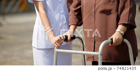 Nurse is helping Senior Elderly Asian Woman uses Zimmer frame walker Nurse is helping Senior Elderly Asian Woman uses Zimmer frame walker 74821435