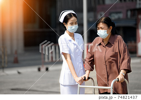 Nurse is helping Senior Elderly Asian Woman uses Zimmer frame walker Nurse is helping Senior Elderly Asian Woman uses Zimmer frame walker 74821437