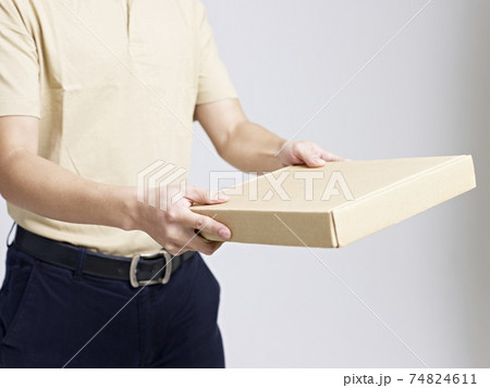 asian male courier company worker delivering a package 74824611