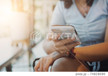 People hand using smartphone to do work business, social network, communication in public cafe. People hand using smartphone to do work business, social network, communication in public cafe. 74828090