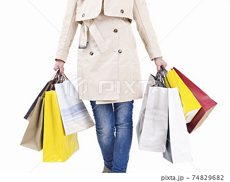 woman walking with colorful shopping bags, studio shot, isolated on white 74829682