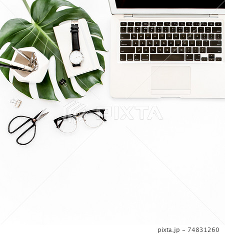 Home office workspace mockup with laptop, tropical leaves Monstera, clipboard, notebook and accessories on white background. Flat lay, top view Home office workspace mockup with laptop, tropical leaves Monstera, clipboard, notebook and accessories on white background. Flat lay, top view 74831260