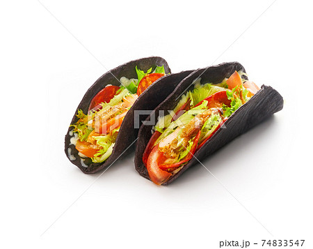 Tacos with grilled vegetables, onion and bell peppers in black tortillas bread on white background, mexican fast food concept Tacos with grilled vegetables, onion and bell peppers in black tortillas bread on white background, mexican fast food concept 74833547