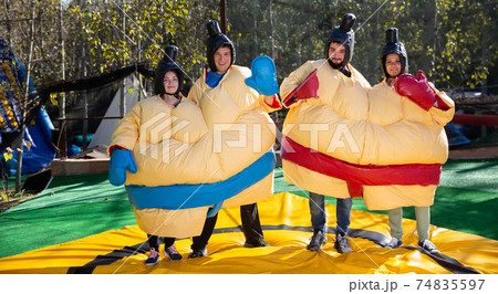 Men and women dressed as sumo wrestlers Men and women dressed as sumo wrestlers 74835597