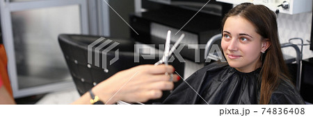 Client choose paint color in book of samples for hair coloring in beauty salon. 74836408