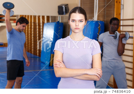 Confident woman standing at fitness center 74836410