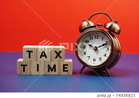 Tax Time alphabet letter with alarm clock on blue and red background Tax Time alphabet letter with alarm clock on blue and red background 74836825