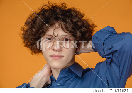 Caucasian young man's portrait isolated on yellow studio background with copyspace Caucasian young man's portrait isolated on yellow studio background with copyspace 74837627