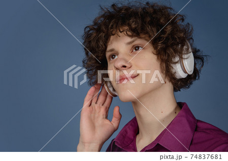 Caucasian young man's portrait isolated on blue studio background with copyspace 74837681