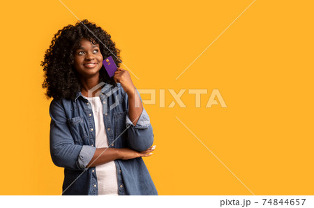 Cheerful young african american woman with credit card, copy space Cheerful young african american woman with credit card, copy space 74844657