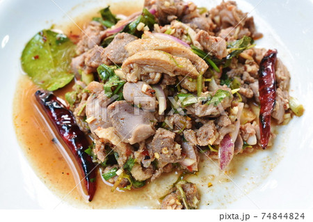 Thai spicy chop duck meat salad and fresh basil leaf with eggplant on plate 74844824