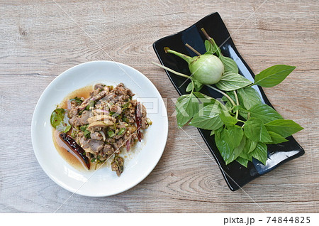 Thai spicy chop duck meat salad and fresh basil leaf with eggplant on plate 74844825