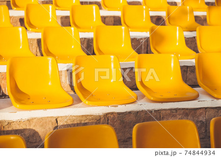 Stone steps with yellow plastic seats. Symbol of closed borders, empty hotels without tourists. Coronavirus COVID-19 quarantine. Hurghada, Egypt. Stone steps with yellow plastic seats. Symbol of closed borders, empty hotels without tourists. Coronavirus COVID-19 quarantine. Hurghada, Egypt. 74844934