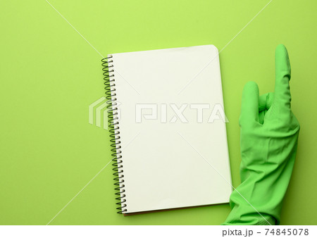 open paper notebook with blank white sheets, green background 74845078