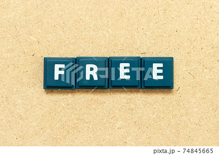 Tile alphabet letter in word free on wood background Tile alphabet letter in word free on wood background 74845665