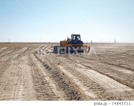 Tractor driver cleans the window. Tractor driver cleans the window. 74845711
