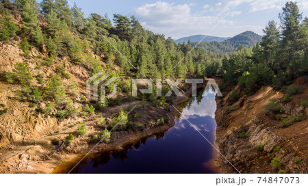 Toxic red lake at abandoned open-pit copper mine Toxic red lake at abandoned open-pit copper mine 74847073