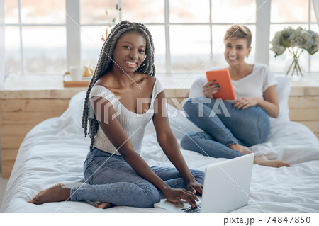 African american girl spending time with her girl-friend at home African american girl spending time with her girl-friend at home 74847850