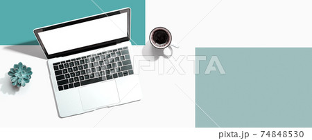 Laptop computer with a coffee cup Laptop computer with a coffee cup 74848530