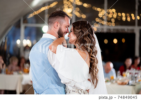 Wedding dance. bride and groom dance in front of guests at end of festive dinner 74849045