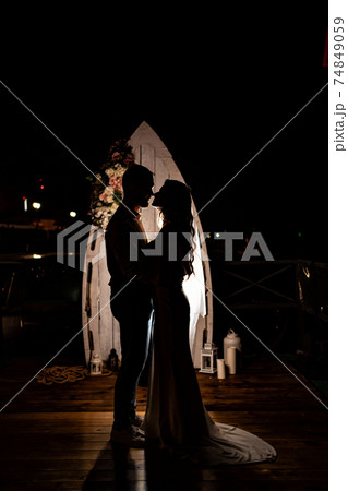 silhouette of the newlyweds in the dark. shooting at night. silhouette of the newlyweds in the dark. shooting at night. 74849059