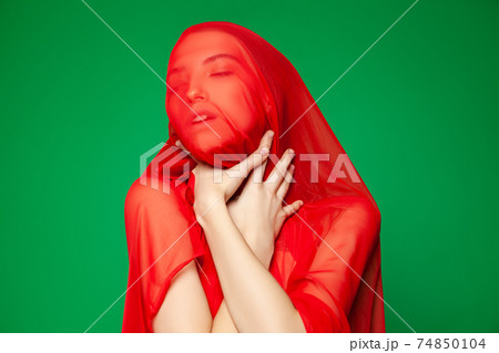 Woman wrapped in red scarf suffering from asphyxia Woman wrapped in red scarf suffering from asphyxia 74850104