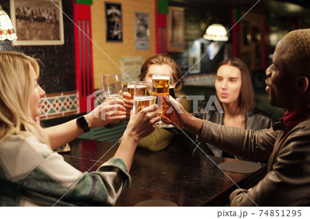 Friends drinking beer during meeting Friends drinking beer during meeting 74851295