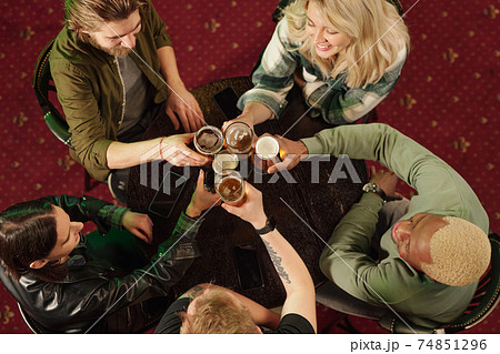 Friends toasting with beer in the bar 74851296