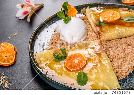 Delicious fresh pancakes on a plate with sweet sauce and ice cream decorated with mint 74851678