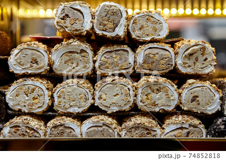 An oriental dessert, or Turkish delight in form of rolls, displa 74852818