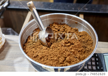 Roasted ground coffee in bowl on counter of coffee shop. Roasted ground coffee in bowl on counter of coffee shop. 74852820