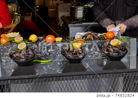 Street restaurant counter with oysters in bowls. Street restaurant counter with oysters in bowls. 74852824