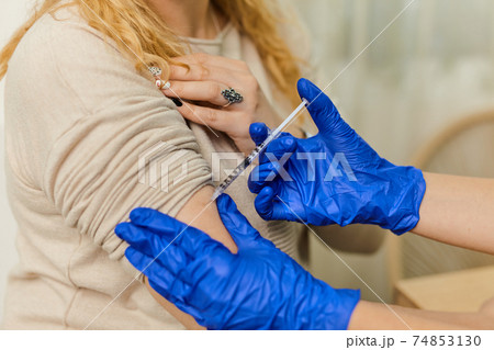 Close up of man vaccinated in a doctor's office Close up of man vaccinated in a doctor's office 74853130