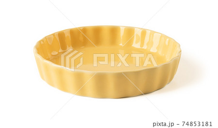 Side view of round yellow ceramic plate with wavy edge isolated on a white background. Side view of round yellow ceramic plate with wavy edge isolated on a white background. 74853181
