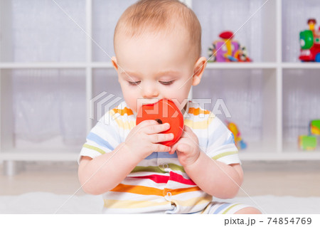 Caucasian baby boy playing with wooden toy. 74854769