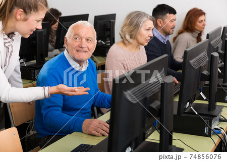 Smiling senior man during computer classes 74856076