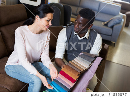 Adult woman with her husband are looking on modern colors for furniture for their house 74856077