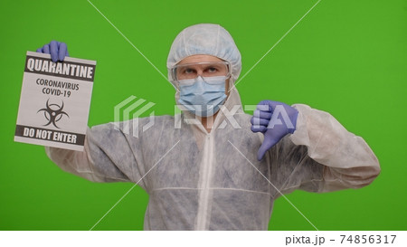 Doctor in suit showing warning text slogan on paper - Quarantine Covid-19 Coronavirus Do Not Enter 74856317
