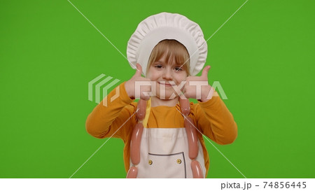 Child girl kid dressed as cook chef showing thumbs up, smiling, looking at camera on chroma key Child girl kid dressed as cook chef showing thumbs up, smiling, looking at camera on chroma key 74856445