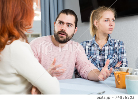 Young serious couple has a family stressful conversation at home Young serious couple has a family stressful conversation at home 74856502