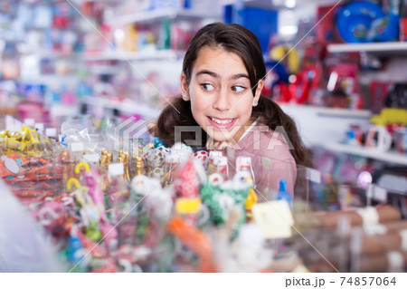 vigorous schoolgirl delighted with choosing lollipop in store vigorous schoolgirl delighted with choosing lollipop in store 74857064