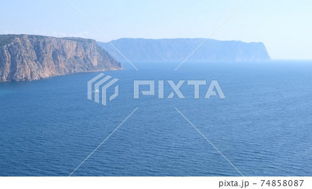 Beautiful view of the coast of the turquoise sea and mountains at Cape Fiolent, Crimea. The concept Beautiful view of the coast of the turquoise sea and mountains at Cape Fiolent, Crimea. The concept 74858087
