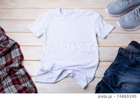 Mens T-shirt mockup with indigo jeans and gray running shoes 74860390