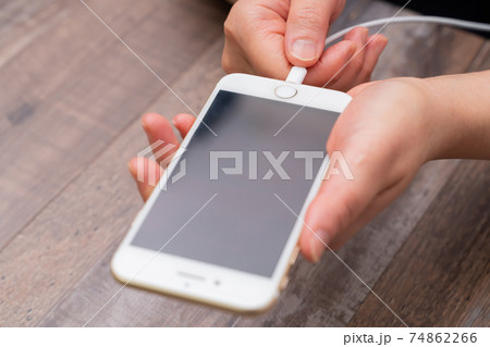 スマホを充電する女性　手元 74862266